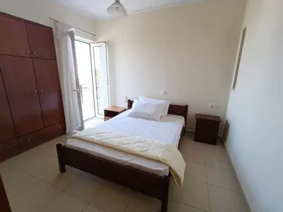 a bedroom with a bed and a large window at Despoina's Sea View Apartment in Chania Town