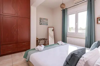 a bedroom with a bed with two hello kitty towels on it at Lumina Apartment with Shared Pool in Perivólia