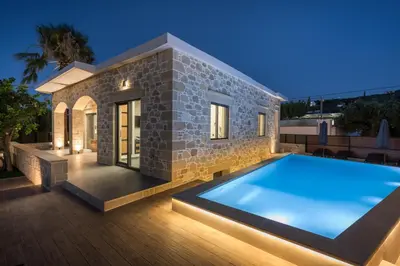 a villa with a swimming pool at night at Luxury villas Argalios in Drapaniás