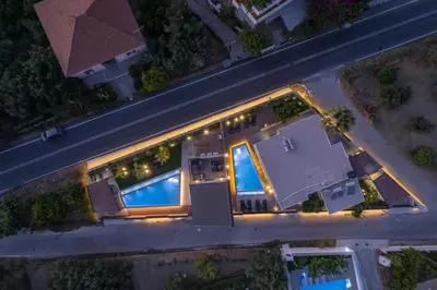 an overhead view of a house with a pool at night at Luxury villas Argalios in Drapaniás