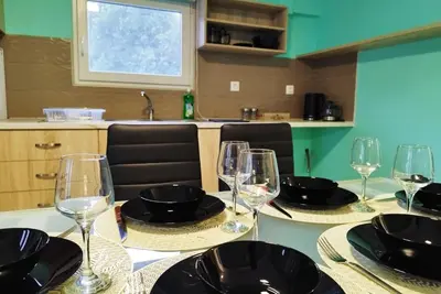 a table with wine glasses and plates on it at SleepiLi in Vrísai