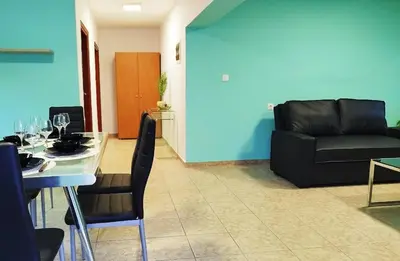 a living room with a table and a couch at SleepiLi in Vrísai