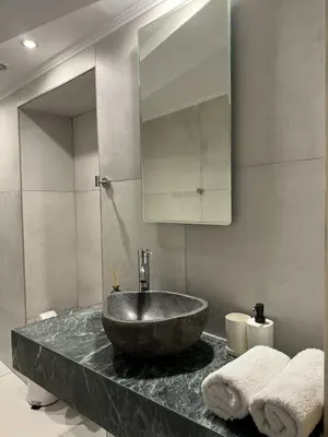 a bathroom with a sink and a mirror at Kasteli Apartment in Kissamos