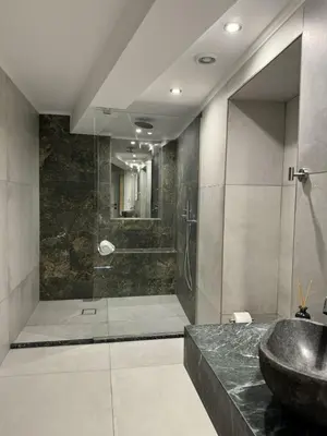 a bathroom with a sink and a shower at Kasteli Apartment in Kissamos