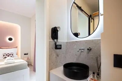a bathroom with a sink and a mirror at Centrale Apartment Chania in Chania Town