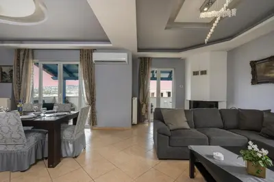 a living room with a couch and a table at Maison Evelyn in Tsikalariá