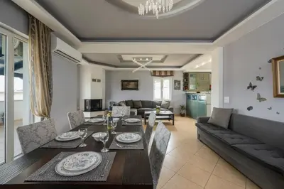 a living room with a dining table and a couch at Maison Evelyn in Tsikalariá