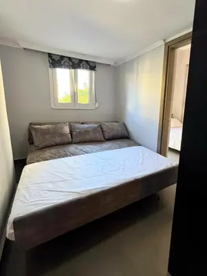 a large bed in a small room with a window at Lia cozy apartment in Chania Town