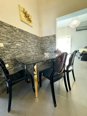 a dining room with a black table and chairs at Lia cozy apartment in Chania Town