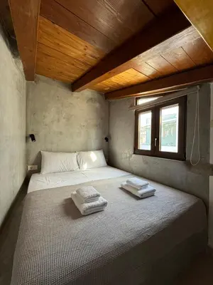 a bed in a room with two towels on it at Kasteli loft apartment in Kissamos