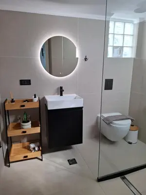 a bathroom with a sink and a toilet and a mirror at Kasteli loft apartment in Kissamos