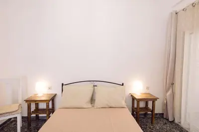a bedroom with a large bed with two tables at Koumbes home in Chania Town