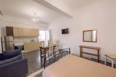 a living room with a couch and a kitchen at Koumbes home in Chania Town