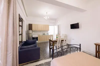 a living room with a couch and a dining room at Koumbes home in Chania Town