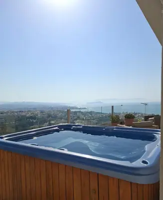 a hot tub on the roof of a house at UPapartment in Chania Town