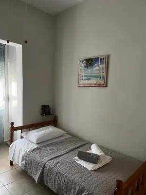 a bedroom with a bed and a picture on the wall at Agnanti in AsfendhilÃ©s