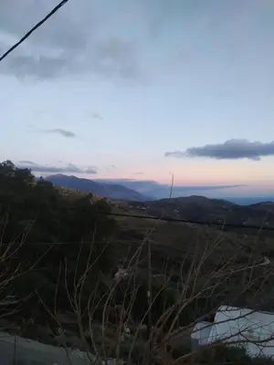 a view from the top of a hill at sunset at Agnanti in AsfendhilÃ©s