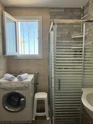 a bathroom with a washing machine and a sink at Agnanti in AsfendhilÃ©s