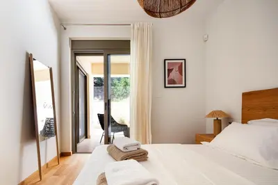 a bedroom with a bed with towels on it at Panorama Seaview Village at Kalyves in Kalyves