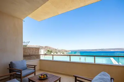a balcony with a view of a swimming pool at Panorama Seaview Village at Kalyves in Kalyves