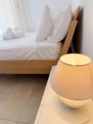 a bedroom with a bed and a lamp on a table at Yia Banaki 1 Min Walk To Beach old Town 7min Walk in Chania Town