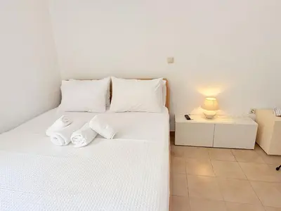 a bedroom with a white bed with towels on it at Yia Banaki 1 Min Walk To Beach old Town 7min Walk in Chania Town