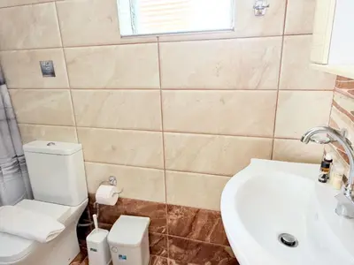 a bathroom with a white toilet and a sink at Yia Banaki 1 Min Walk To Beach old Town 7min Walk in Chania Town