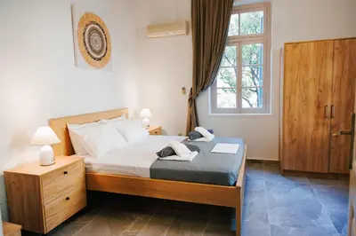 a bedroom with a bed and a window at Be Crete - Villa Erofili in Chania Town