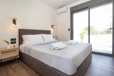 a bedroom with a large bed with towels on it at PhySea Villa in Kalathas
