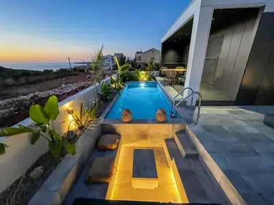 a swimming pool on the side of a house at PhySea Villa in Kalathas
