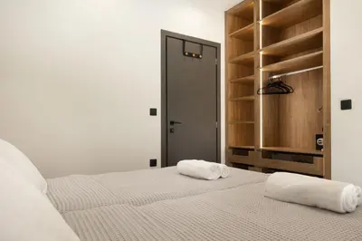 a bedroom with two white towels on a bed at PhySea Villa in Kalathas