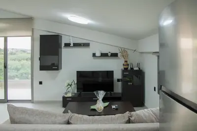 a living room with a couch and a table at Welcome U in Gerani Chanion