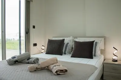 a bedroom with two beds with towels on them at Welcome U in Gerani Chanion