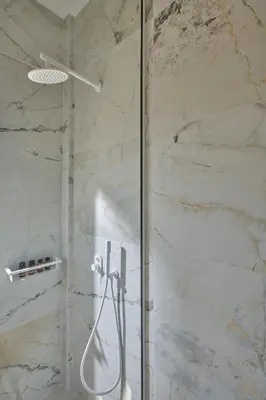 a shower with a glass door in a bathroom at Mantis' House in Chania Town
