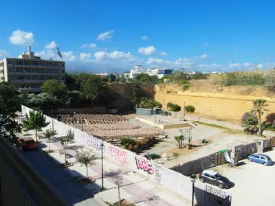 a view of a parking lot with graffiti on a wall at Mantis' House in Chania Town