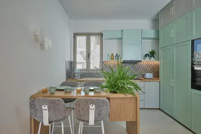 a kitchen with a wooden table and chairs at Mantis' House in Chania Town