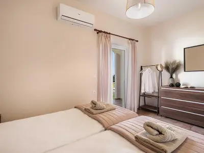 a bedroom with a bed with two towels on it at Casa Horizon in Palaiochóra