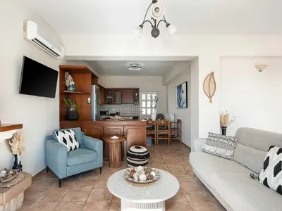 a living room with a couch and a table at Casa Horizon in Palaiochóra