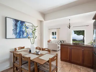 a kitchen and dining room with a table and chairs at Casa Horizon in Palaiochóra