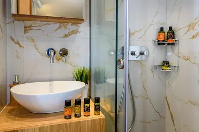 a bathroom with a sink and a glass shower at Nicolas Urban Luxury Living in Souda