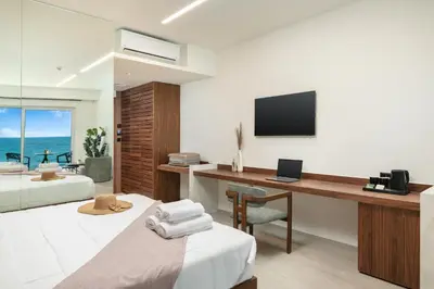 a bedroom with a desk and a bed with a computer at Elia Sea Suites in Chania Town