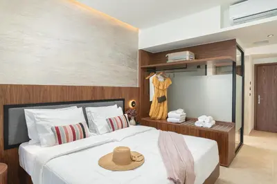 a bedroom with a bed with a hat on it at Elia Sea Suites in Chania Town