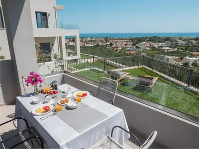 a white table with food and drinks on a balcony at Panoramic view villa - Selita in Tavronitis