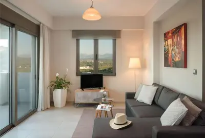 a living room with a couch and a tv at Panoramic view villa - Selita in Tavronitis