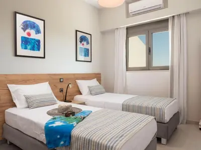 a hotel room with two beds and a window at Panoramic view villa - Selita in Tavronitis