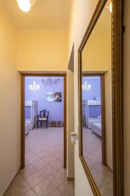 a hallway with a mirror and a living room at Kaloudis Apartment in Kissamos