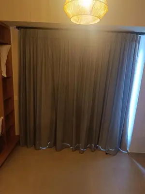 a room with a curtain and a chandelier at Talos in Sougia