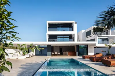 an external view of a house with a swimming pool at Nuera Villas in Chania Town