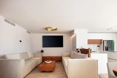 a living room with a couch and a tv at Nuera Villas in Chania Town