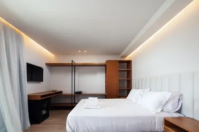 a bedroom with a bed and a desk and a television at Nuera Villas in Chania Town